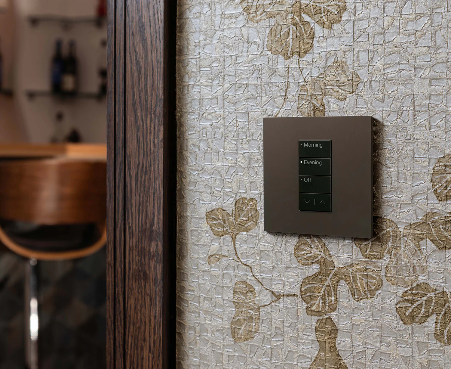 A bronze Lutron keypad set flush into a textured wall